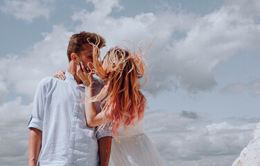 bride and groom against the sky