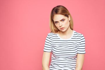 Obraz premium Woman in striped t-shirt emotions studio cropped view lifestyle pink isolated background