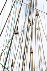 Low angle closeup of a mast of a sailing vessel on a sunny day © Kristians Berents/Wirestock