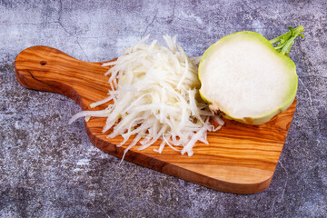 Fresh kohlrabi cabbage on wooden cutting board