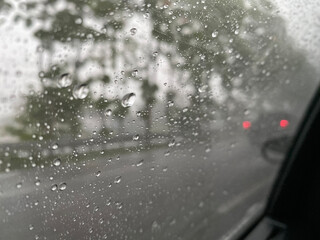 Rain on car window waiting in traffic jam