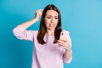 Photo of cute horrified troubled young woman hold telephone finger head city government want demolish house for building highway wear violet pullover isolated blue color background