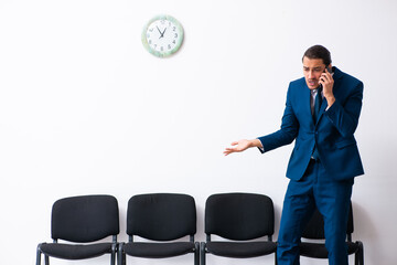 Young businessman waiting for an interview at hall