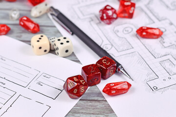 Red tabletop role playing RPG game dices on blurry hand drawn dungeon map and character sheet