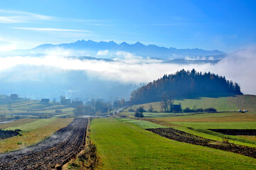 Obraz premium Blurred view over Tatra Mountains over fog at sunrise in Pieniny, Poland