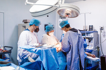 Latin doctor performing surgery with hispanic assistants in Mexico