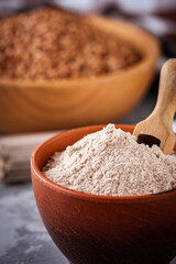 fresh natural buckwheat flour on a dark stone background culinary concept