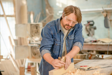 Fototapeta na wymiar Carpenter planed wood in a workshop
