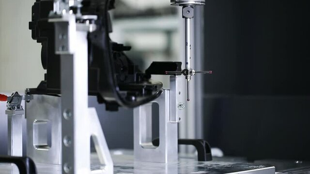Close up of a 3D dimension measurement plastic parts by CMM, 3D automatic measuring system, automotive industrial concept, smart factory