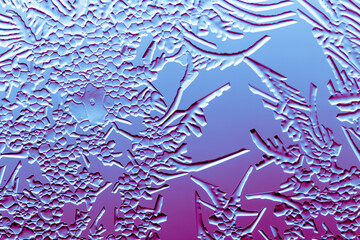 Blue-pink patterns from frost on glass as a background.