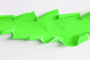 ripped green torn paper on white paper background
