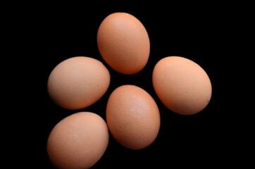 Chicken eggs on a black background. Ingredients for salad and various dishes.