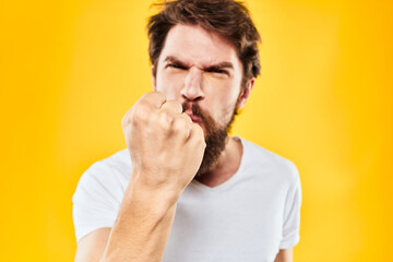 bearded man gesturing with hands studio lifestyle discontent yellow background