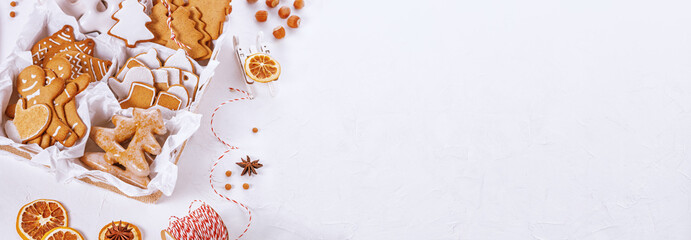 Top view of unpacked christmas present with sweets on a white textured surface, banner, close-up. Christmas celebration concept with space for text