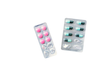 Medicine panel of pink and green capsules medicine isolated on white background - Clipping path