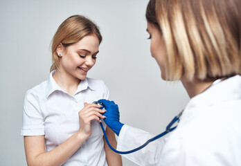 nurse with blue gloves and medicine stethoscope patient