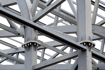 Row of stadium roof metal supports structure. Industrial steel background.