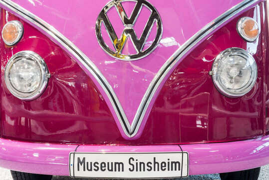 SINSHEIM, GERMANY - APRIL 8, 2018:nFront of a pink bus vintage car with inscribed license plate "Museum Sinsheim" and largelogo in the technic museum Sinsheim