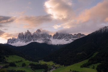 Sunrise over the small Italian mountain town of St. Magdalena in Val di Funes