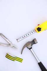 Top view of Set of construction and maintenance tooling for handyman on white concrete background with copy space