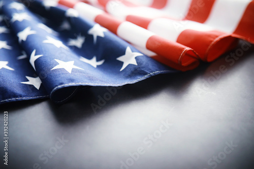 Flapping flag USA with wave. American flag for Memorial Day or 4th of July. Closeup of American flag dark background