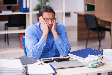 Young male bookkeper in budget planning concept