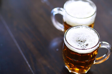 Glass of fresh beer on a wooden table. Lager beer mug on stone table. Top view with copy space