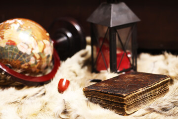 Retro old book and world desk globe on fur, learning and education concepts.