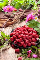 Summer still life with, raspberries, flowers and meadow grasses.