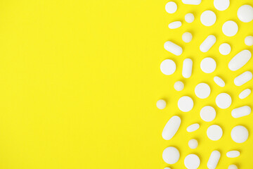 Bright yellow background with white medicine tablets
