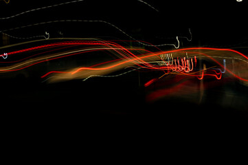 Bright orange neon glowing fast moving streams of light, along a trajectory. Fast energy flying...
