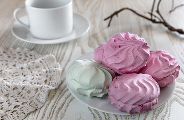 Breakfast with red currant marshmallows and light green Apple with a tea Cup on a white background