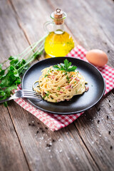 Spaghetti alla carbonara. Pasta with pancetta, egg, parmesan cheese and cream sauce.  - 392423656