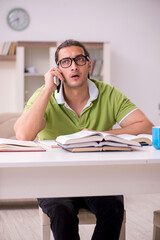 Young male student preparing for exams at home