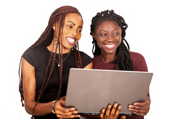 two young sisters holding a laptop