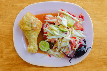 papaya salad with fried chicken on dish