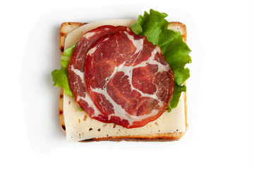 A slice of toasted bread , a piece of cheese, a lettuce leaf and two pieces of smoked meat