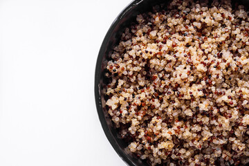 bowl of healthy quinoa on a white acrylic background