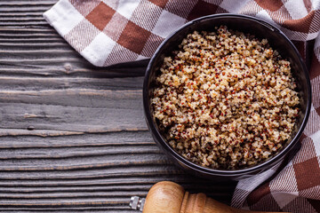 bowl of healthy quinoa on a dark wooden rustic background