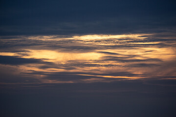 Naklejka na ściany i meble Sunset sky with clouds and orange and blue tones