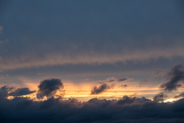 Sunset sky with clouds and orange and blue tones