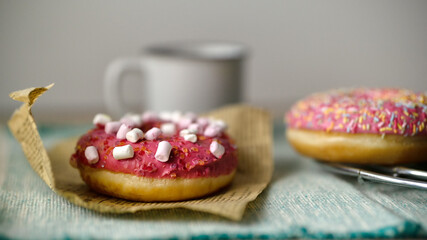 Close up view of delicious tasty glazed sprinkled with marshmallow donuts