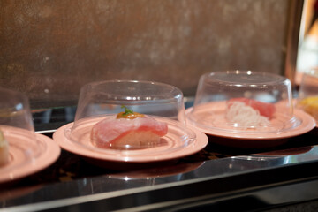 Selective focus of Tuna sushi on conveyor belt
