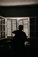 silhouette of a person in a window