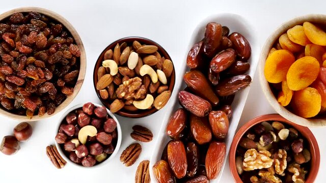 dried fruit and nuts on white background