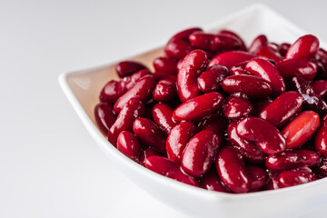 canned red kidney beans on a white acrylic background