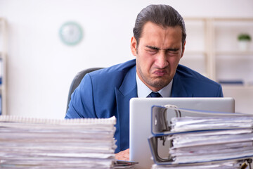 Young male employee unhappy with excessive work