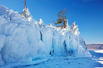 Lake Baikal in winter. Rocks of Ogoy island covered with icicles. 