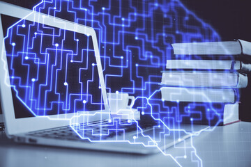 Double exposure of work space with computer and human brain drawing hologram. Brainstorm concept.
