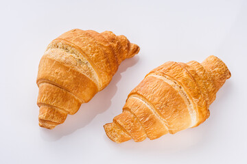 delicious fresh croissant on a white acrylic background